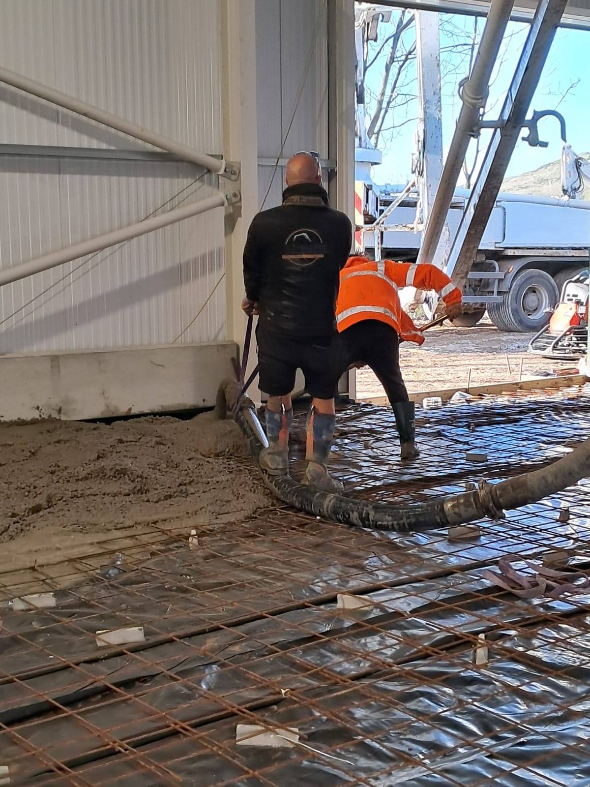 Concrete boom pump crew preparing a large commercial rebar pour